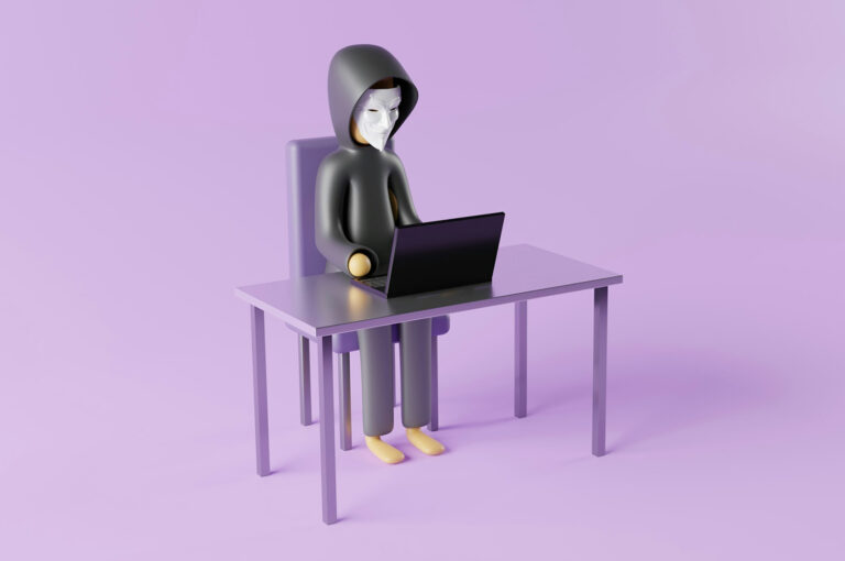 A masked figure in a hoodie typing on a laptop, illustrating how WordPress sites get hacked